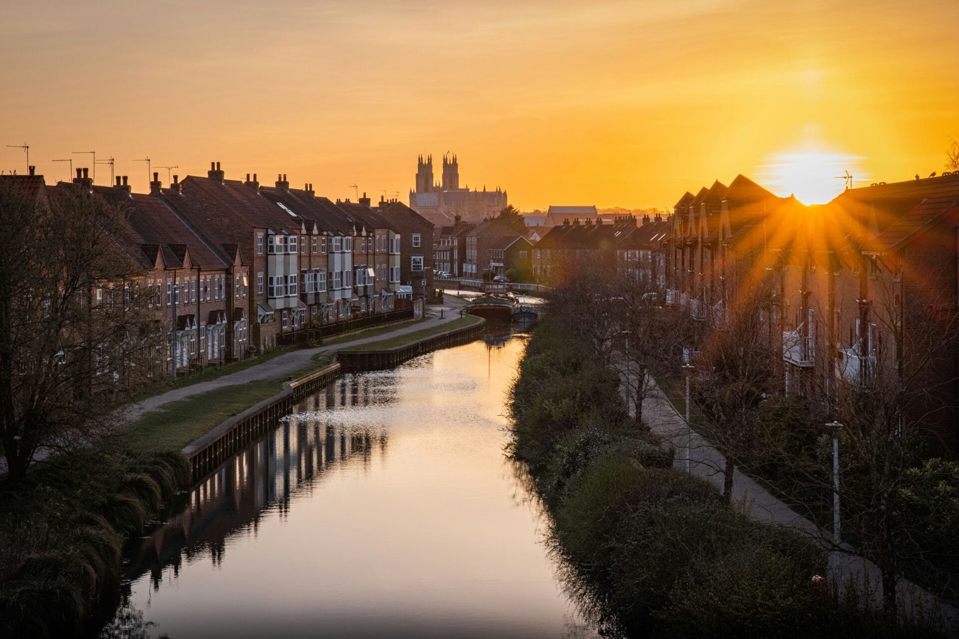 Terraced houses along a canal at sunset