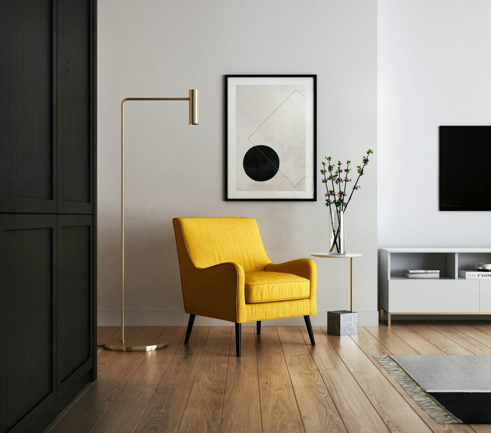Yellow armchair beside a brass floor lamp and a framed print