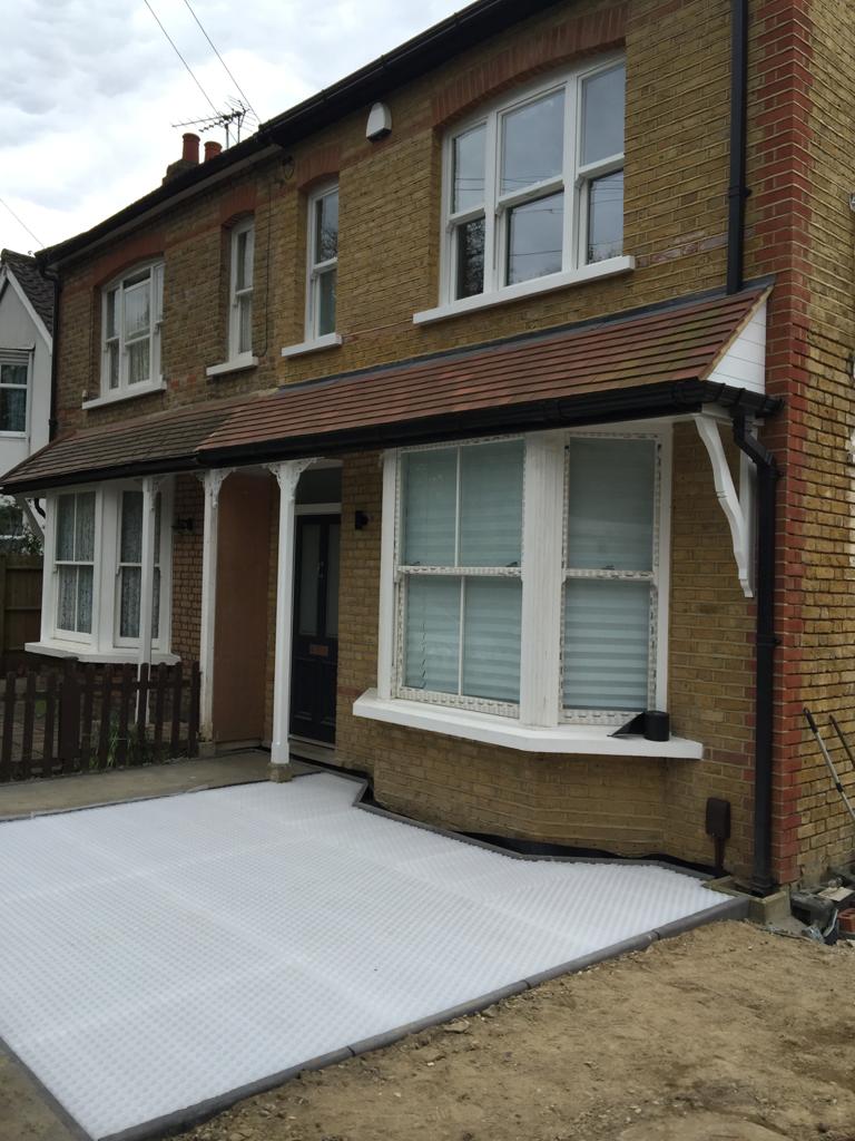 Yellow-brick Victorian semi-detached house with a bay window